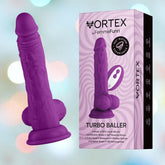 A purple silicone vibrator shaped like a penis is displayed next to its packaging. The white and purple box features the product name "Femme Funn Wireless Turbo Baller - Purple" by Femme Funn. Equipped with a suction base, remote control, and 8 powerful vibration modes, it’s also 100% waterproof for versatile pleasure.